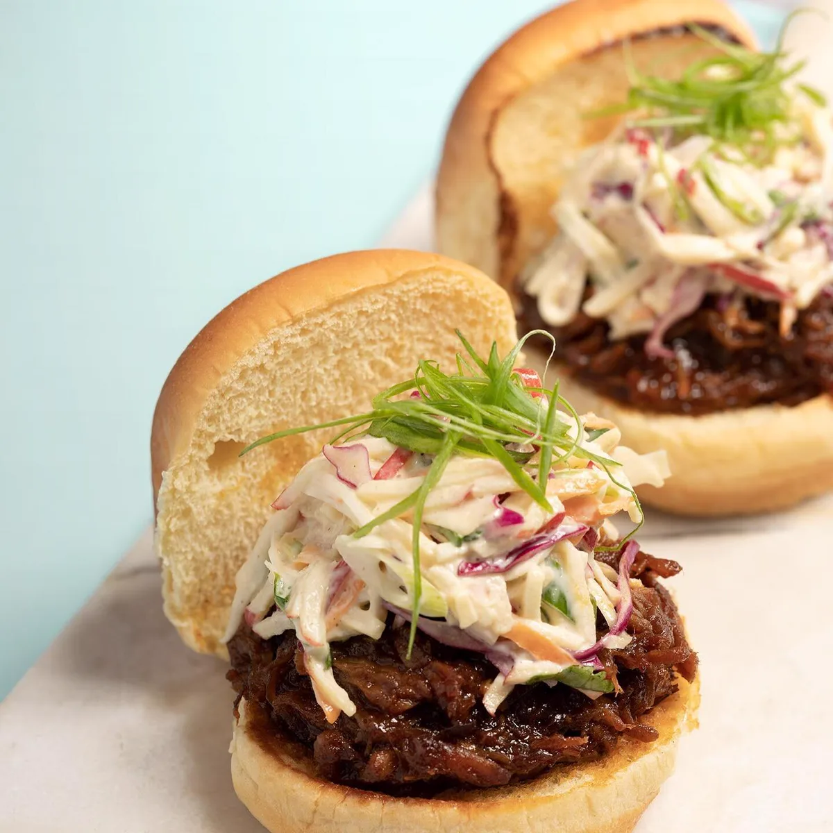 Bourbon BBQ pulled pork sliders topped with slaw