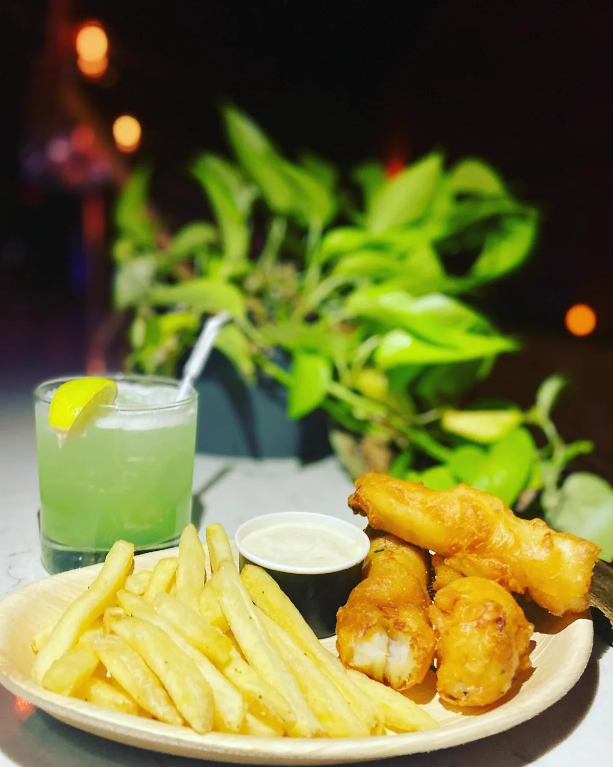 A green cocktail with fish and chips at L'Wren