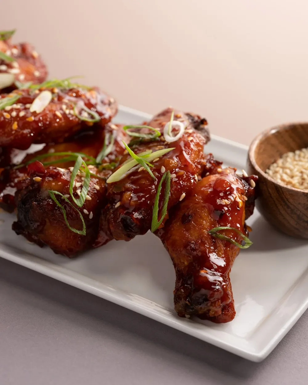 Korean style wings with scallions and sesame seeds