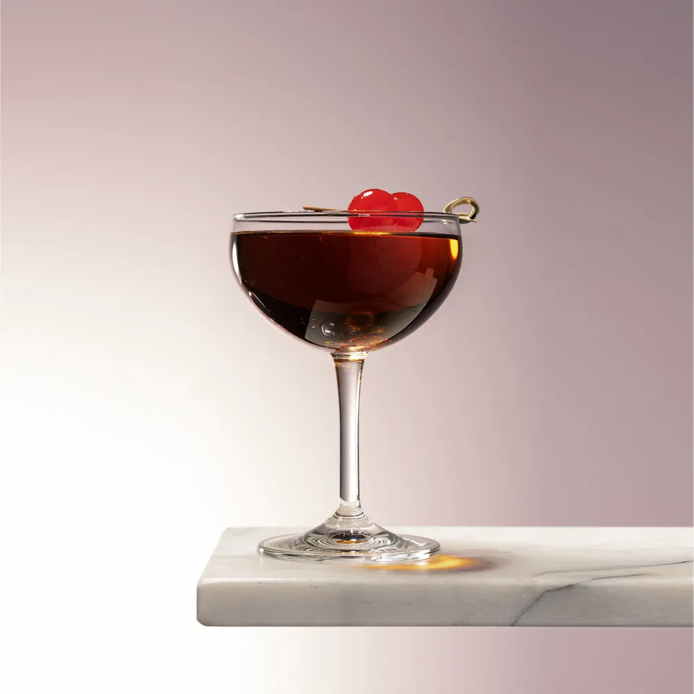Sunset Manhattan in a coupe with a cherry